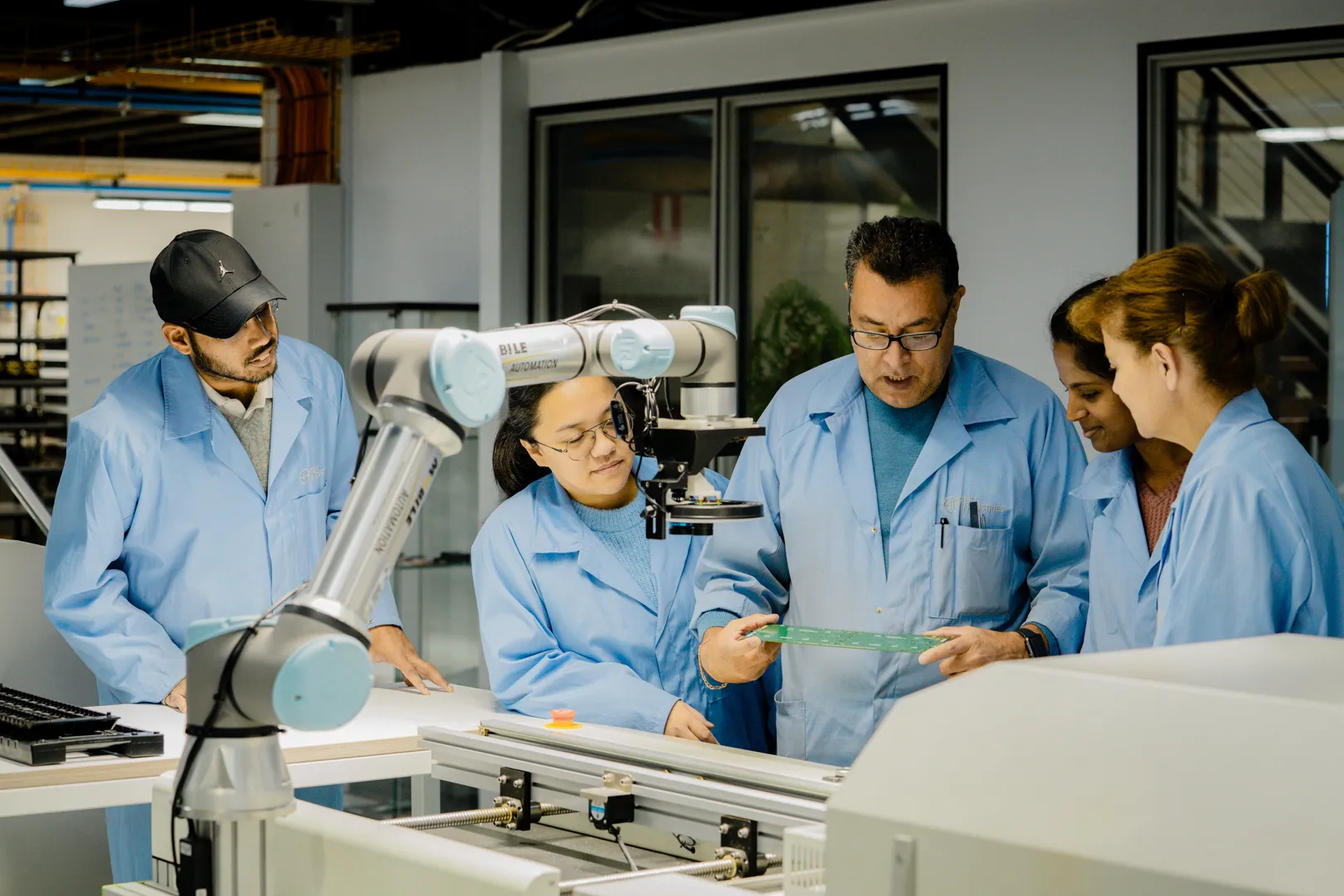 Production team reviewing a circuit board