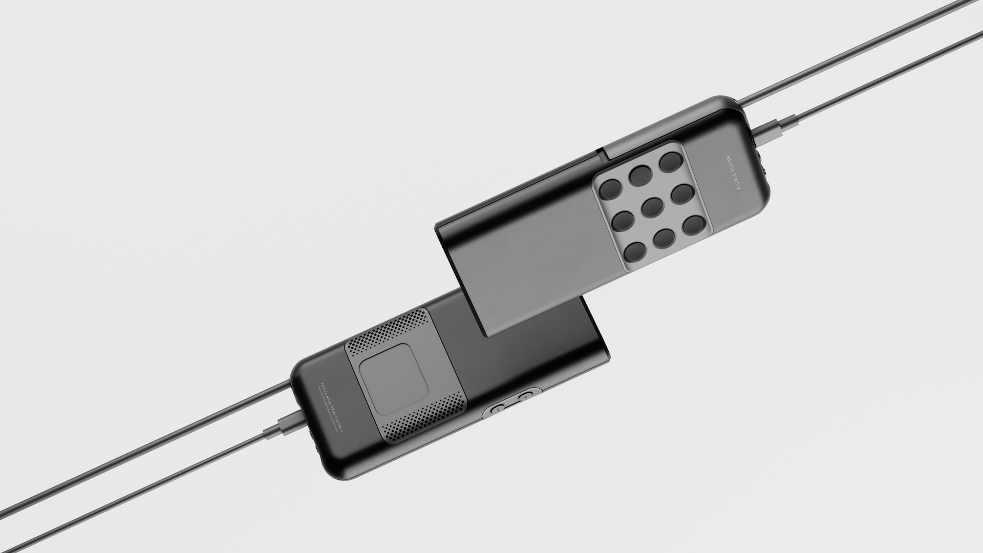 Two Bionic Vision control units, one carrying a three-by-three grid of tactile pads, both marked for clinical trial use only