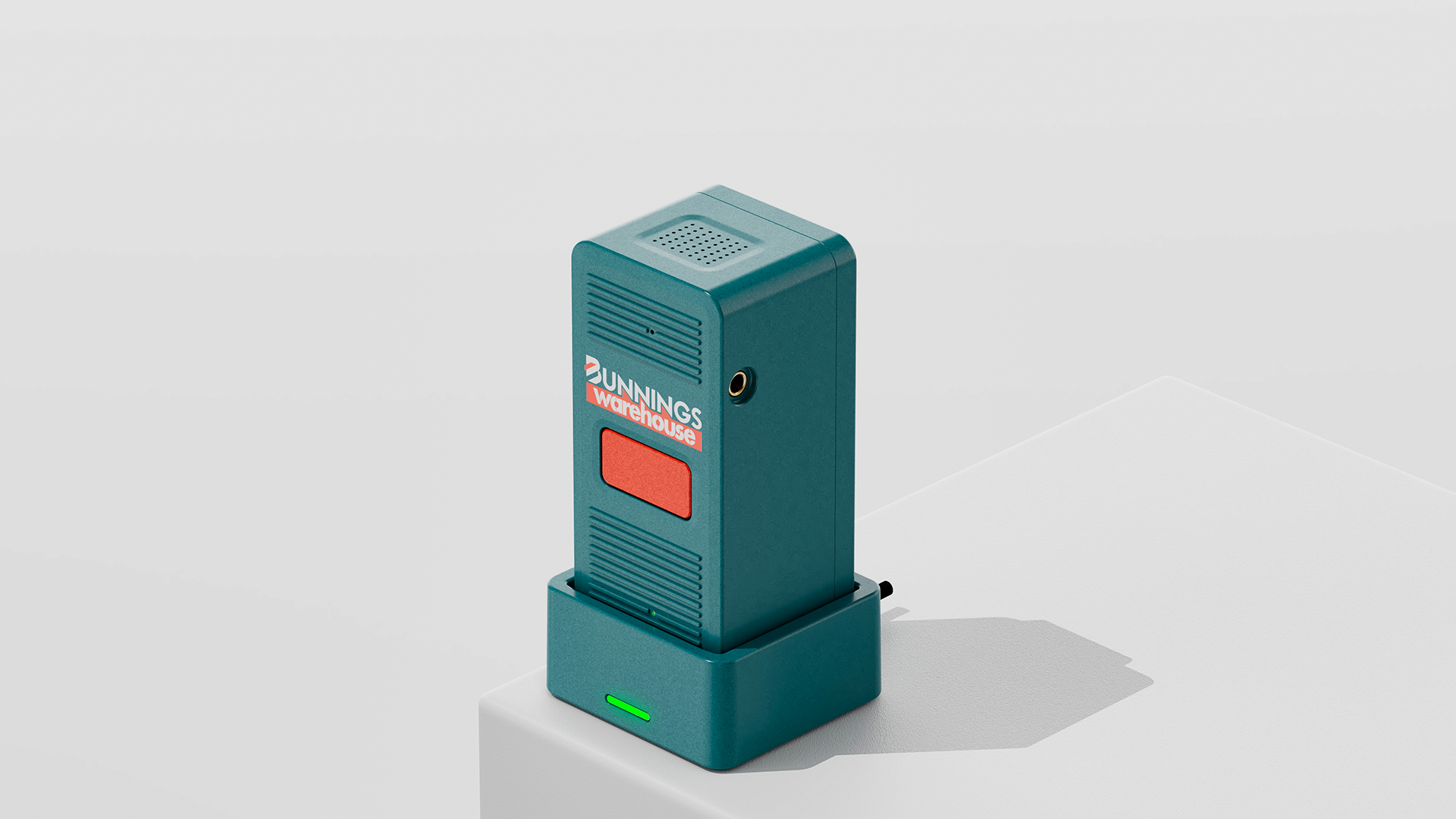 Teal Bunnings-branded voice intercom endpoint with a red talk button, docked in its charging cradle with a green light lit