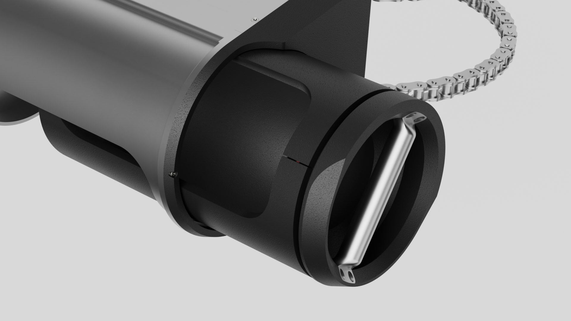 Close-up of the feeder barrel's mouth, a stainless bar across the black rotating opening and a roller chain looped behind